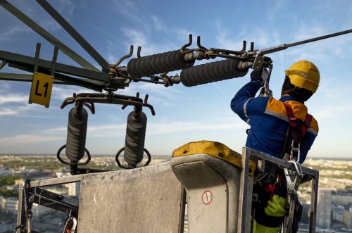 Electrical engineer repairing the electrical network on an elevation boom